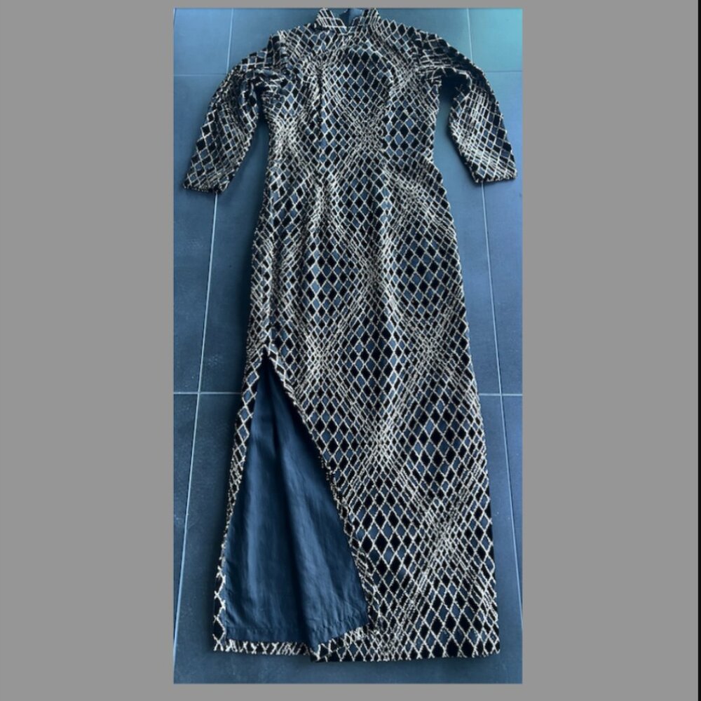 Oriental elegant long cheongsam in black and gold pattern